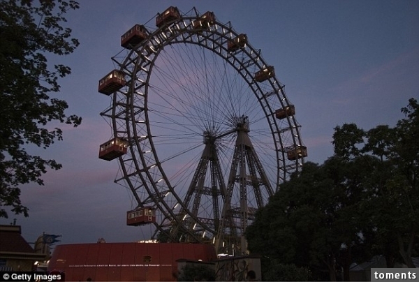The couple were left trapped at the top of Vienna's ferris wheel (pictured) after a staff member, unaware there was a couple still riding it, shut it down and went home for the evening