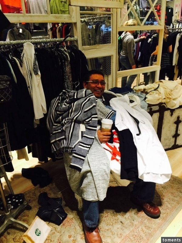 This papa-bro waiting for his wife and daughter outside a dressing room: