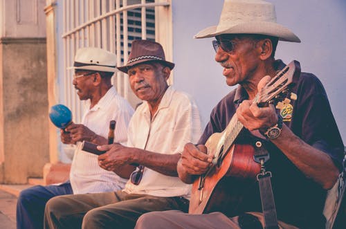 Three Men Playing Musical Instruments